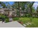 Spacious backyard features lush lawn, trees and patio perfect for entertaining and outdoor living at 450 Andrews Dr, Longwood, FL 32750