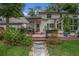 Backyard brick patio lined with plants and stone pathway offers a peaceful outdoor space at 450 Andrews Dr, Longwood, FL 32750