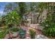 Beautiful backyard with brick patio, mature trees, and lush plants creating a private outdoor space at 450 Andrews Dr, Longwood, FL 32750