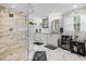 Bright bathroom featuring marble floors, glass enclosed shower, dual sinks and white cabinets at 450 Andrews Dr, Longwood, FL 32750