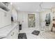 Bright bathroom featuring marble floors, glass enclosed shower, dual sinks and white cabinets at 450 Andrews Dr, Longwood, FL 32750