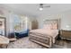 Cozy bedroom with a mirrored bed frame, ceiling fan and warm, inviting decor at 450 Andrews Dr, Longwood, FL 32750