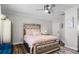 Cozy bedroom with a mirrored bed frame, ceiling fan and warm, inviting decor at 450 Andrews Dr, Longwood, FL 32750
