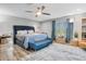 Comfortable bedroom with a ceiling fan, wooden floors, and stylish furnishings at 450 Andrews Dr, Longwood, FL 32750