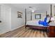 Bright bedroom featuring stylish wood floors, a four-poster bed, and an adjacent closet, offering a cozy retreat at 450 Andrews Dr, Longwood, FL 32750