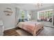 Charming bedroom with a window seat, chandelier and wood laminate flooring at 450 Andrews Dr, Longwood, FL 32750