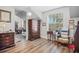 Inviting bedroom featuring wood floors, an antique dresser, and a comfortable chair, creating a cozy and stylish space at 450 Andrews Dr, Longwood, FL 32750