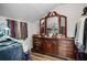 Walk in closet with wooden dresser and vanity, providing ample storage for clothing and accessories at 450 Andrews Dr, Longwood, FL 32750