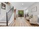 Inviting entryway with a staircase, wood floors, and decorative furnishings at 450 Andrews Dr, Longwood, FL 32750