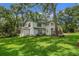 Sprawling two-story home with a large lawn and mature trees, creating a serene and inviting atmosphere at 450 Andrews Dr, Longwood, FL 32750