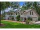 Spacious two-story home with white brick exterior, mature landscaping, and attached two-car garage at 450 Andrews Dr, Longwood, FL 32750