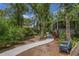 Charming home featuring a paved walkway, lush greenery, and a screened-in porch, perfect for outdoor enjoyment at 450 Andrews Dr, Longwood, FL 32750