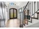 Welcoming foyer with soaring ceilings, wood floors, and an elegant staircase with iron railings at 450 Andrews Dr, Longwood, FL 32750