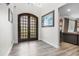 Grand foyer with high ceilings, beautiful wooden flooring, and a striking arched doorway at 450 Andrews Dr, Longwood, FL 32750