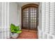 Elegant front entrance with brick flooring, a unique wooden door, and brick accents at 450 Andrews Dr, Longwood, FL 32750