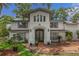 Stunning white brick home featuring a charming arched entryway and meticulously landscaped garden at 450 Andrews Dr, Longwood, FL 32750