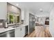 Sunlit kitchen featuring stainless steel appliances, a wine cooler, and views to the Gathering room at 450 Andrews Dr, Longwood, FL 32750