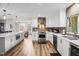 Modern kitchen with stainless steel appliances and view to the dining and living areas at 450 Andrews Dr, Longwood, FL 32750