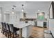 Bright kitchen features a marble countertop island, stainless steel appliances, and hardwood flooring at 450 Andrews Dr, Longwood, FL 32750
