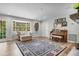 Cozy living room featuring large rug, bay window, and a piano at 450 Andrews Dr, Longwood, FL 32750