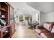 Spacious living room features wood floors, a comfortable leather couch, and a built-in bookshelf, perfect for relaxation at 450 Andrews Dr, Longwood, FL 32750