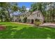 Inviting home featuring a manicured lawn, brick driveway leading to an attached garage at 450 Andrews Dr, Longwood, FL 32750