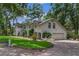 Beautifully landscaped home featuring a well-manicured lawn, brick driveway, and an attached garage at 450 Andrews Dr, Longwood, FL 32750