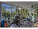 Bright exercise room with large windows, ceiling fan, and views of nature, perfect for home fitness at 450 Andrews Dr, Longwood, FL 32750