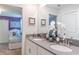 Contemporary bathroom with double sinks and view into purple bedroom at 4501 Target Blvd, Kissimmee, FL 34746