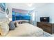 Bright bedroom featuring a king bed, wooden dresser, and calming blue accents at 4501 Target Blvd, Kissimmee, FL 34746