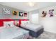 The bedroom is designed with a Mickey Mouse theme and features two twin beds with red headboards at 4501 Target Blvd, Kissimmee, FL 34746