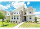 Beautiful two-story home featuring a stone column and well-manicured lawn at 4501 Target Blvd, Kissimmee, FL 34746
