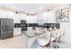 Modern kitchen with stainless steel appliances, white cabinetry, and breakfast bar at 4501 Target Blvd, Kissimmee, FL 34746