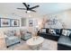 Comfortable living room with a leather sectional sofa, accent chairs, and a world map mural at 4501 Target Blvd, Kissimmee, FL 34746