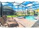 Inviting screened-in pool and spa area with lounge chairs to relax and enjoy the Florida sun at 4501 Target Blvd, Kissimmee, FL 34746