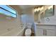 This bathroom features a window, tub, and white vanity at 4510 Ravinnia Dr, Orlando, FL 32809