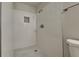 This modern bathroom features a stand up shower, gray tile floors, and white brick style walls at 4510 Ravinnia Dr, Orlando, FL 32809