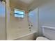 This bathroom features a window and white tub at 4510 Ravinnia Dr, Orlando, FL 32809