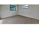 This bedroom features neutral carpeting, windows, and light gray walls at 4510 Ravinnia Dr, Orlando, FL 32809