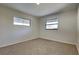 Bedroom featuring neutral carpet, windows and fresh paint at 4510 Ravinnia Dr, Orlando, FL 32809