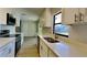 Updated kitchen featuring stainless steel appliances, quartz countertops, and ample storage at 4510 Ravinnia Dr, Orlando, FL 32809