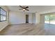 Open living room with laminate floors, fresh paint and a sliding glass door to the backyard at 4510 Ravinnia Dr, Orlando, FL 32809
