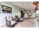 Back porch with two wicker chairs and a coffee table at 456 Willowbrook Ln, Longwood, FL 32779