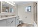 Bright bathroom with a double sink vanity, large mirror, and shower-over-tub combination at 456 Willowbrook Ln, Longwood, FL 32779