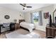 Bedroom with wood-look floors, ceiling fan, and window with a view to the outside at 456 Willowbrook Ln, Longwood, FL 32779