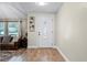 Bright foyer with hardwood floors and decorative door; living area with leather furniture visible at 456 Willowbrook Ln, Longwood, FL 32779