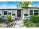 Inviting entryway with a stylish front door, manicured landscaping, and a charming walkway at 456 Willowbrook Ln, Longwood, FL 32779