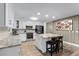 Bright kitchen boasts stainless steel appliances, a center island with seating, and white cabinetry at 456 Willowbrook Ln, Longwood, FL 32779