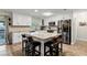 Bright kitchen featuring a large island with seating, stainless steel appliances, and white cabinetry at 456 Willowbrook Ln, Longwood, FL 32779