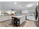 Open-concept kitchen showcasing a center island with barstools, flowing into the living area at 456 Willowbrook Ln, Longwood, FL 32779
